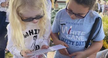 Two girls playing with braille cards   